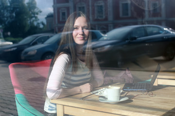 girl behind glass in cafe