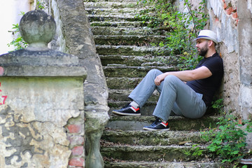 man sit on abandoned stair