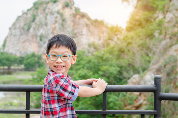 Young asian boy smiling in park