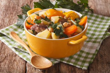 Pouchero hot dish Close-up in a pot on the table. Horizontal
