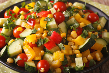 Low calorie salad of corn, tomatoes, cucumbers and pepper close-up. horizontal
