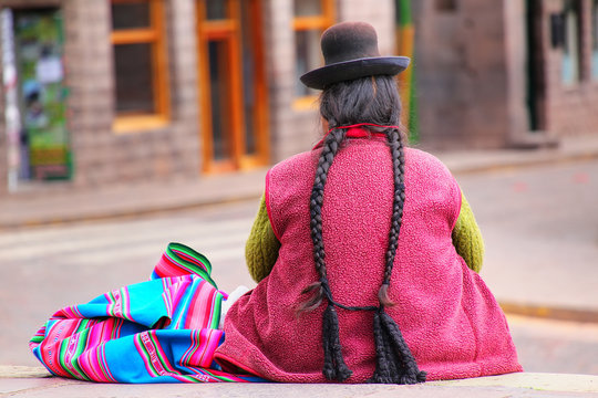 Local woman sitting at Plaza de Armas in Cusco, Peru