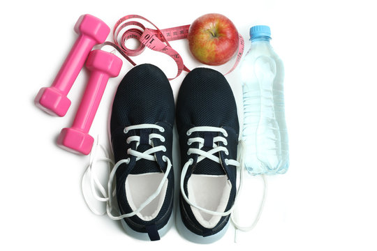 Sneakers, apple, centimeter, dumbbell isolated on a white background. Fitness. Sport.