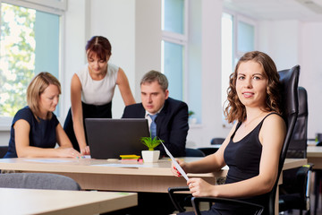 Fototapeta premium Portrait of curly business woman in the office in a chair on the