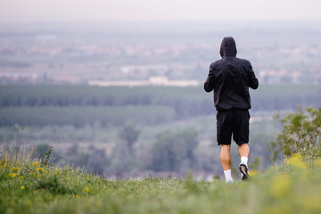 Athletic young man running in the nature. Healthy lifestyle