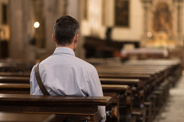 Man sitting at Church - Powered by Adobe