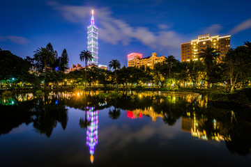 Fototapeta premium Taipei 101 and a lake at Zhongshan Park at night, in Xinyi, Taip