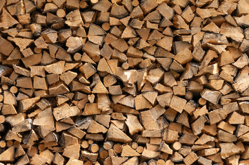 Chopped brown firewood, stacked, texture