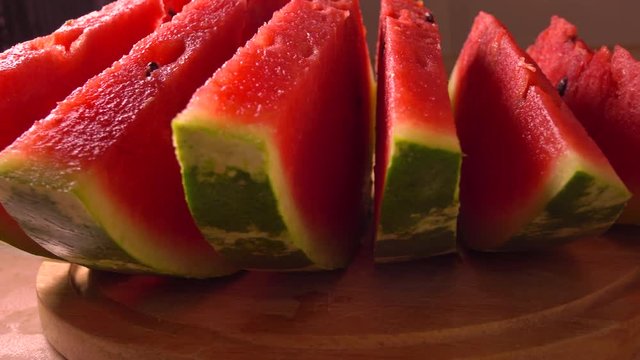 Row of watermelon slices closeup 4K pan shot