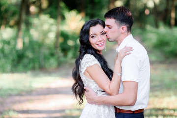 Beautiful luxury newlyweds posing outside