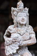 Fototapeta na wymiar Stone statuette of the deity in a Balinese temple
