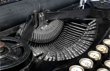 Antique typewriter, close-up photo mechanism, top view on a white background, view of the mechanism and view of the old font.