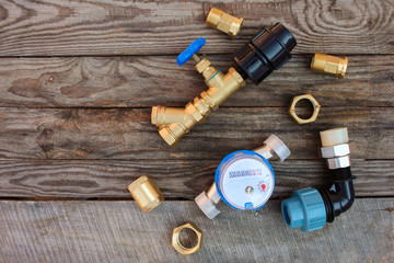 Plumbing equipment on wooden background.