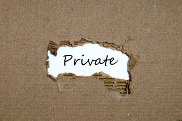 The word private appearing behind torn paper