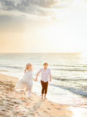 Beautiful stylish couple walking on the beach