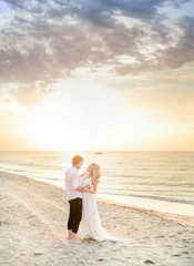 Beautiful stylish couple posing on the beach