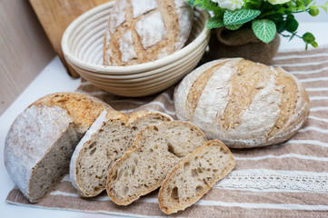 freshly baked homemade whole wheat grain bread on tablecloth