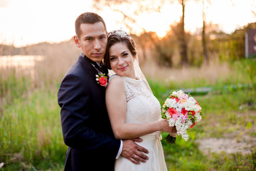 Groom is hugging his lovely happy wife