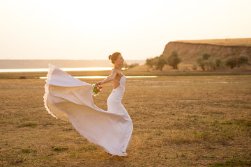 Fototapeta na wymiar Bride dancing in sunset light