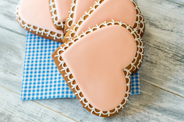 Heart shaped biscuits on napkin. Cookies with light pink glaze. Dessert cooked with love. Express your care.