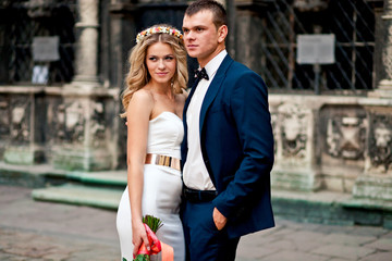 Amazing wedding couple is standing and posing