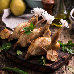 Fresh organic quails on vintage wooden table, healthy food