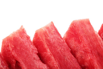diagonal row of bright red watermelon slices. isolated on white background