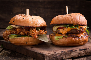 Tasty grilled burger with lettuce and mayonnaise ,on a rustic wooden table