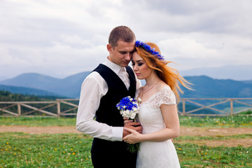 Cute and romantic wedding couple in mountains