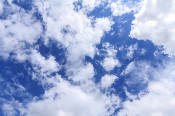 Blue sky with white clouds. The vast blue sky and clouds sky on sunny day. White fluffy clouds in the blue sky.
