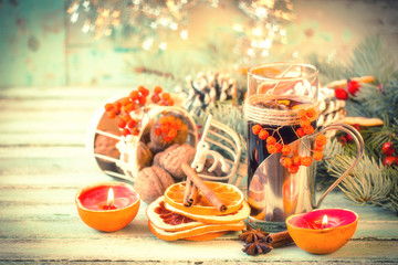 Fototapeta na wymiar mulled wine with orange and spices on wooden background.Christmas decoration