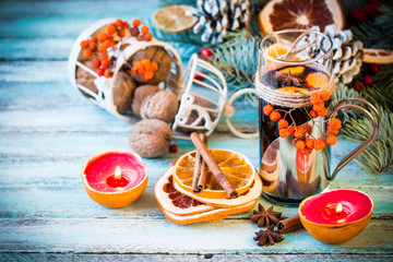 mulled wine with orange and spices on wooden background.Christmas decoration