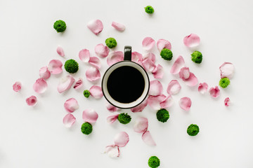 Fototapeta na wymiar Colorful bright image made of leaves, roses and petals with coffee cup on white. flat lay, top view