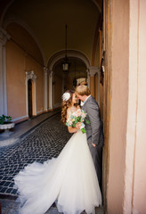 Pretty bride in amazing white dress with her handsome groom
