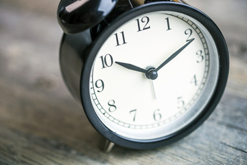 alarm clock on wooden table