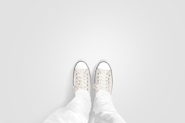 Person taking photo of his foots stand on blank floor, isolated, top view, clipping path. Ground design mock up. Man wear gumshoes and watching down. Deck flooring mockup template. - Powered by Adobe