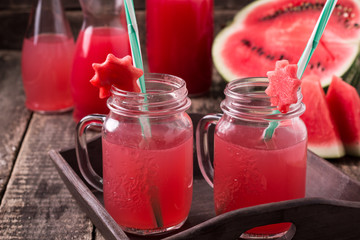 Watermelon drink in glasses with slices of watermelon mint and lemon,