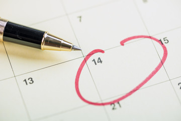 Pen on calendar with red circle. planning concept