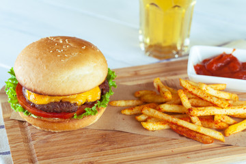 burger and french fries on wooden table