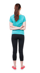 back view of standing young beautiful  woman. girl  watching. Rear view people collection.  backside view of person.  Isolated over white background. Hands behind his back runner looks ahead.