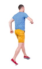 Back view of running man in t-shirt and shorts. Walking guy in motion. Rear view people collection. Backside view of person. Isolated over white background.