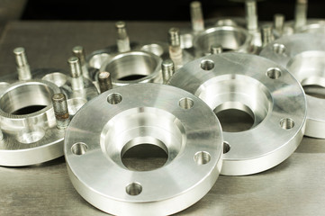 Metal mold of wheel spacers and bolts. CNC industry - obrazy, fototapety, plakaty