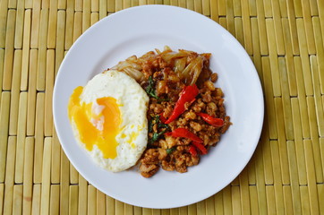 fried rice noodle and spicy chop pork with basil leaf topping egg