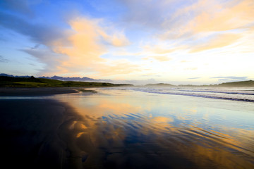 Fototapeta na wymiar Sandy beach at Sunset in Westport of New Zealand.