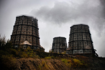 cooling towers of a nuclear power plant. concept gloomy state environment. Dark toned image.