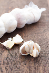 garlic bulbs with garlic cloves on a wooden table