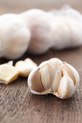garlic bulbs with garlic cloves on a wooden table
