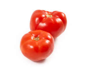 A tomato. Red tomato on a white background. Harvest vegetables. Autumn harvest. Red, juicy, ripe tomato.