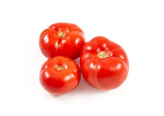 A tomato. Red tomato on a white background. Harvest vegetables. Autumn harvest. Red, juicy, ripe tomato.