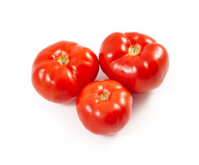 A tomato. Red tomato on a white background. Harvest vegetables. Autumn harvest. Red, juicy, ripe tomato.